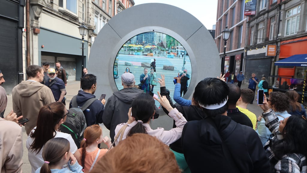Crowds gathered at the North Earl Street portal in Dublin greeting people in New York City. Photograph: The Irish Times