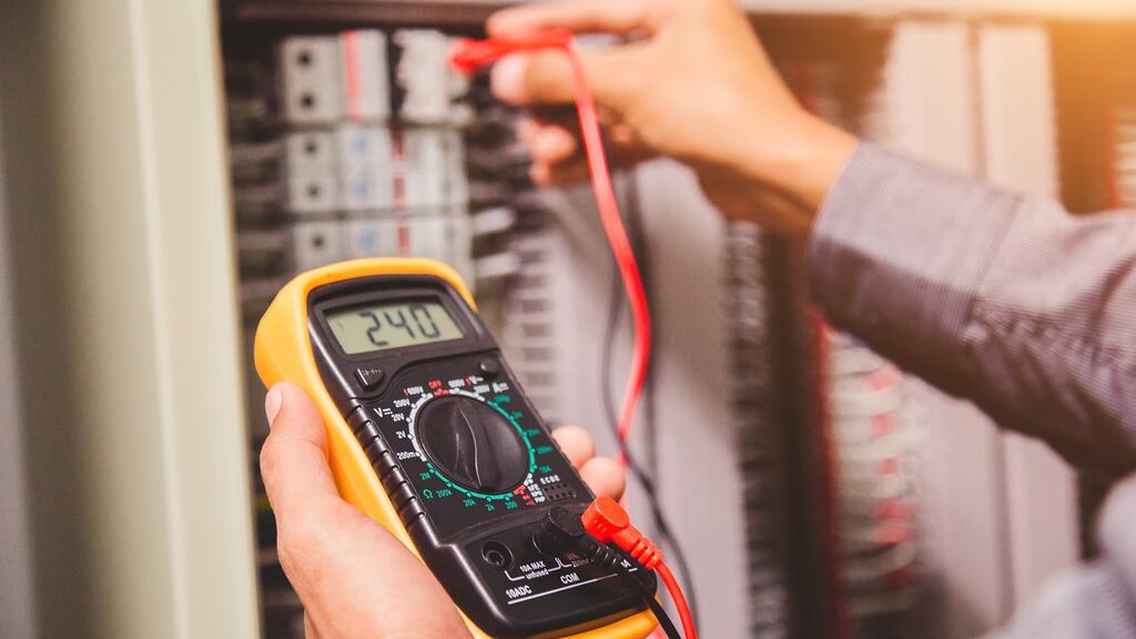 An engineer measuring voltage or current. Having links with less “windy” systems means that surplus power can be exported when the wind blows in Ireland
