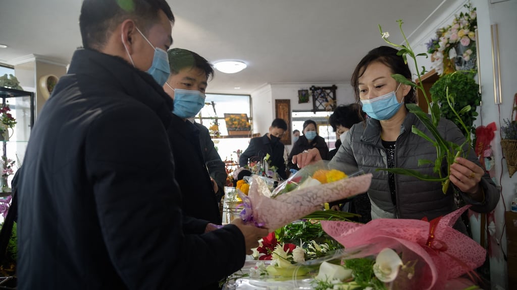 A man buys flowers at a stall near the Pyongyang railway station on March 8h, 2021, International Women’s Day. Photograph: Kim Won-jin/AFP via Getty Images