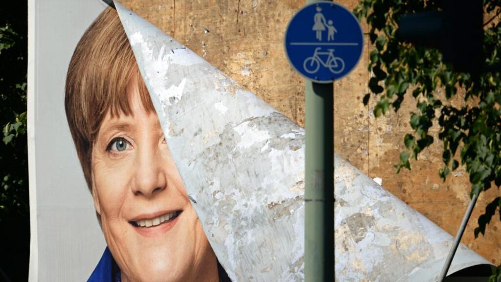A damaged CDU election poster with German Chancellor Merkel for the EU election campaign in Potsdam, Germany. Photograph: Ralf Hirschberger/EPA