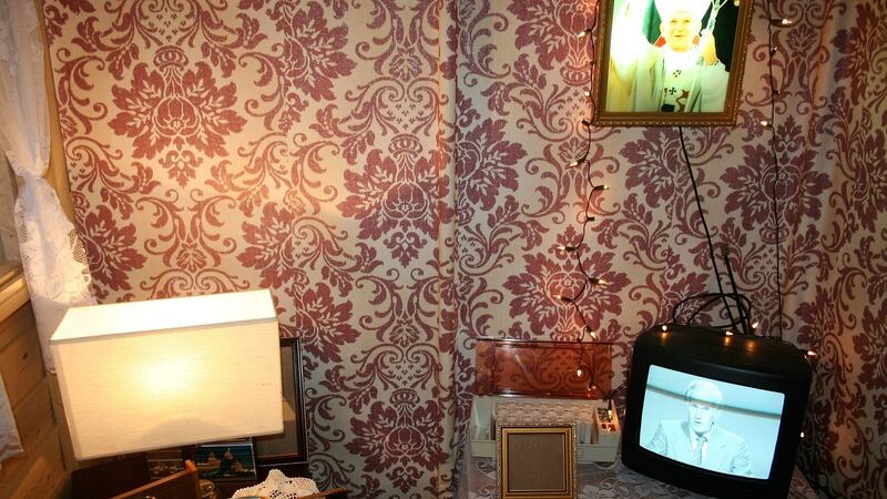 Its interior is fitted out with flock wallpaper, a black and white television and a picture of the Pope.