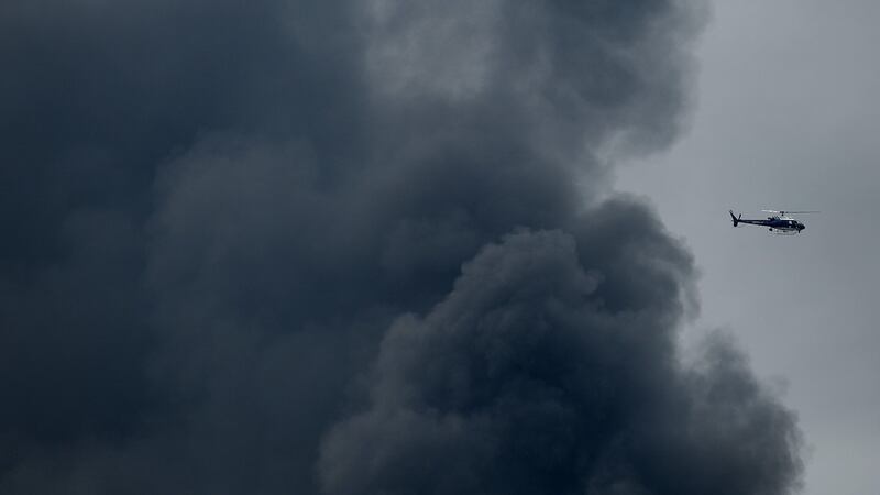 A helicopter circles around as smoke billows from a train derailment that caused a major explosion in the Rosedale neighborhood in Baltimore, Maryland. Residents in nearby neighborhoods were advised to voluntarily evacuate. Photograph: Patrick Smith/Getty Images.