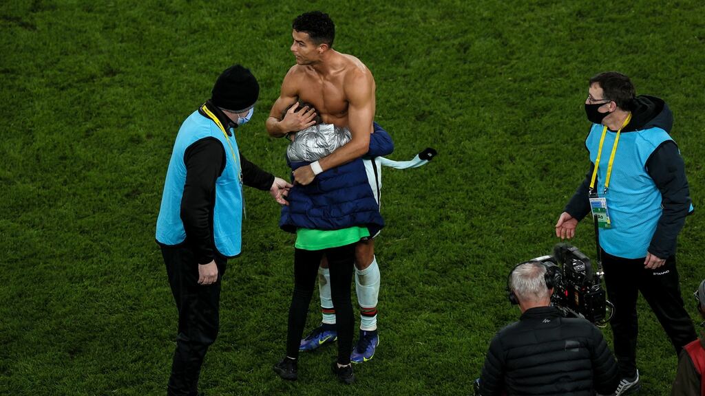 Cristiano Ronaldo gives his jersey to Addison Whelan (11), who ran onto the pitch after the final whistle at the World Cup qualifier between Ireland and Portugal at Aviva Stadium on Thursday night. Photograph: Ben Brady/Inpho