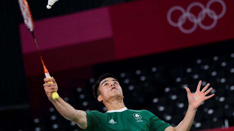 Nhat Nguyen hits a shot against Niluka Karunaratne in their men’s singles badminton group stage match. Photo: Pedro Pardo/AFP via Getty Images