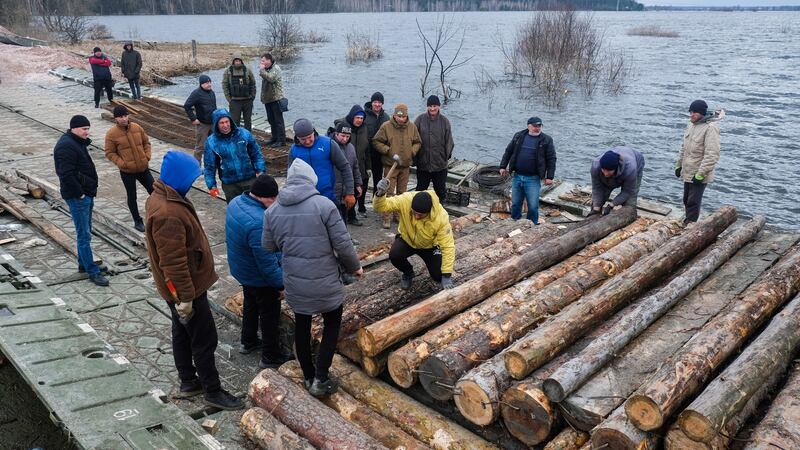 Soldiers and civilians repair a destroyed bridge over the Irpin river in Demydiv on the outskirts of Kyiv on April 6th. With the withdrawal of Russian troops from Kyiv’s villages, some civilians who left are returning home. Photograph: Matthew Hatcher/SOPA Images/LightRocket via Getty Images