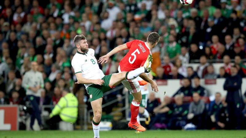 Daryl Murphy and James Chester jump for the ball during Ireland’s 1-0 win over Wales. Photograph: Ryan Byrne/Inpho