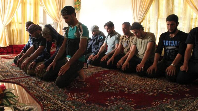 Free Syrian Army fighters perform their prayers in Khirbet Ghazaleh, Daraa, last week. Photograph: Thaer Abdallah/Reuters