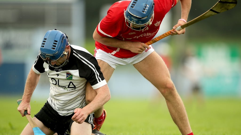Keith Kennedy of JK Brackens and Conor Booth of Roscrea during their Tipperary Senior Hurling Championship game at Éire Óg Nenagh GAA club on Saturday. Photograph: James Crombie/Inpho