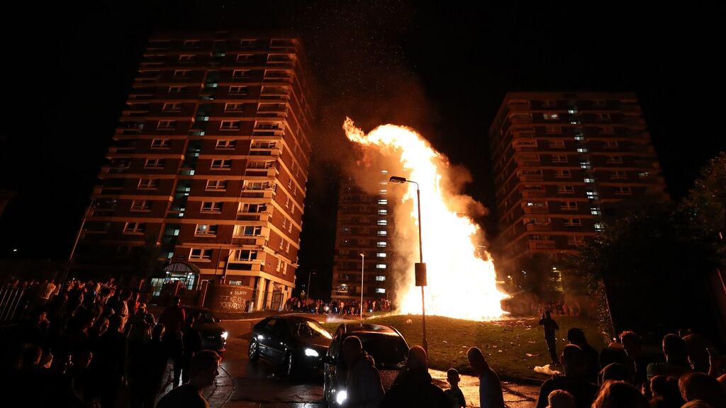 Crowds watch as a bonfire is lit in the New Lodge area of Belfast to mark the anniversary of the introduction of the controversial policy of internment without trial. Photograph: PA Wire