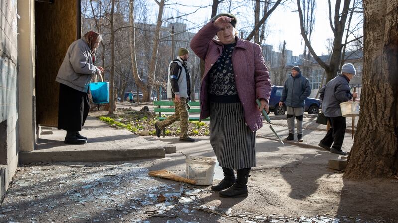 Residents assess the damage at an apartment building hit by overnight shelling in Mykolaiv. Photograph: Tyler Hicks/The New York Times