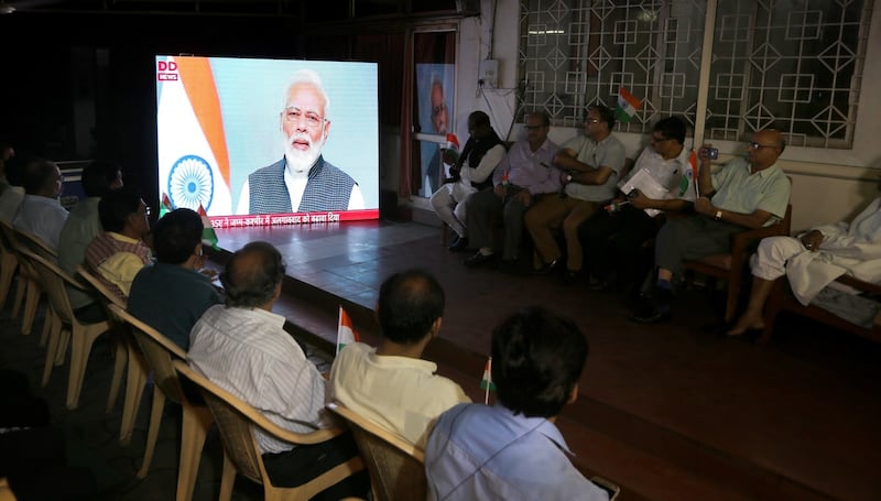 People watch a live address by Indian prime minister Narendra Modi after the government scrap Article 370, in Bhopal, India. Photograph: Sanjeev Gupta/EPA