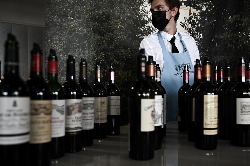 A waiter looks on next to Bordeaux wine bottles during the official Semaine des Primeurs in April in Bordeaux. Photograph: Philippe Lopez/AFP via Getty Images
