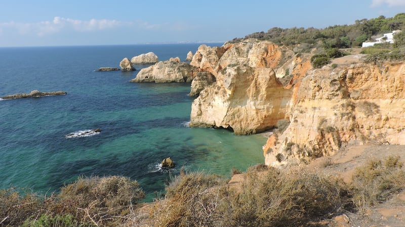 The top of the picturesque town of Carvoeiro opens up to the sea, with a small sandy beach protected by golden cliffs on either side