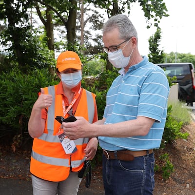 Volunteer Kate McCartney checking a member of the public’s appointment details on arrival at Citywest vaccination centre. Photograph: Alan Betson