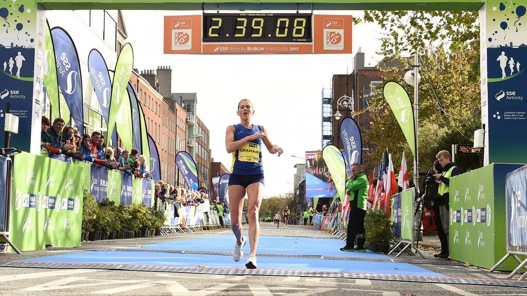 Laura Graham of Mourne Runners, Co Down, crosses the line at Merrion Square in Dublin city to be the first Irish finisher in the women’s category of the Dublin Marathon. Photograph: Sam Barnes/Sportsfile
