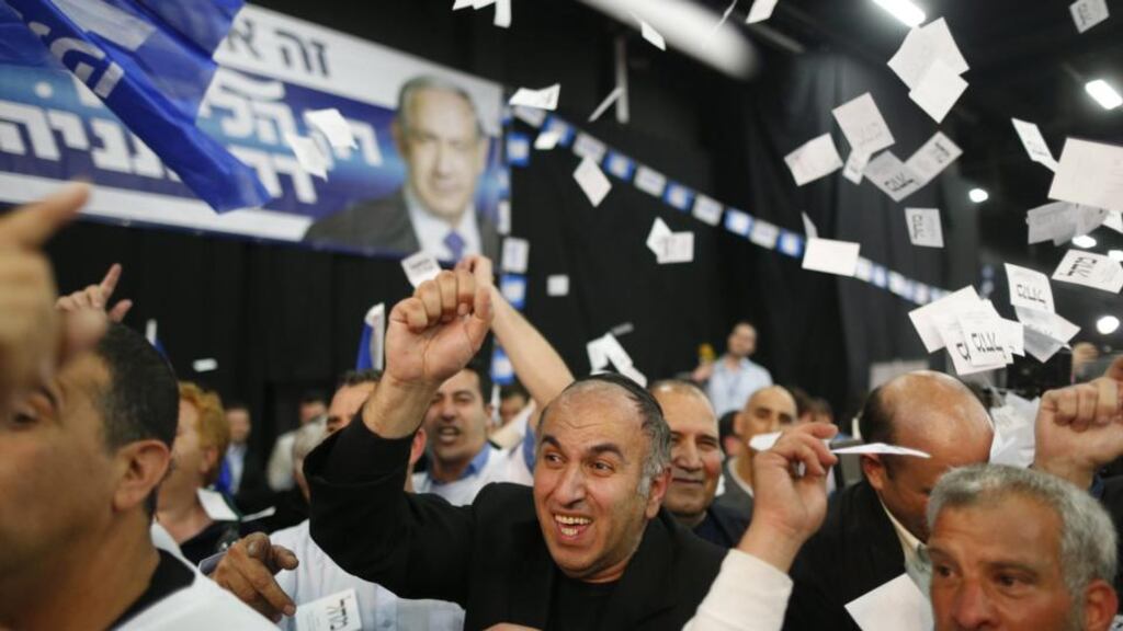 ‘The election had been called by Netanyahu not so much to steal a march on a rejuvenated opposition to his left but to strengthen his hand in dealings with cabinet allies to his right.’ Above: supporters of Benjamin Natanyahu cheer as they hear the first  predictions of the Israeli election results. Photograph: Abir Sultan/EPA