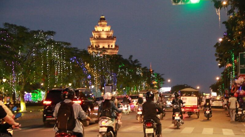 Motorists drive by the iconic Independence Monument in Phnom Penh. Photograph: Nevenka Lukin