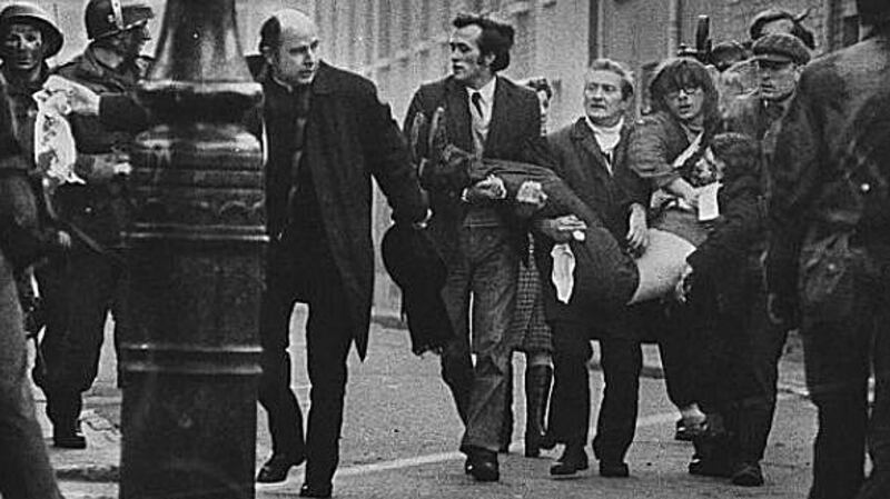 Bloody Sunday: Fr Edward Daly waves a bloodied white handkerchief after soldiers opened fire on protesters.
