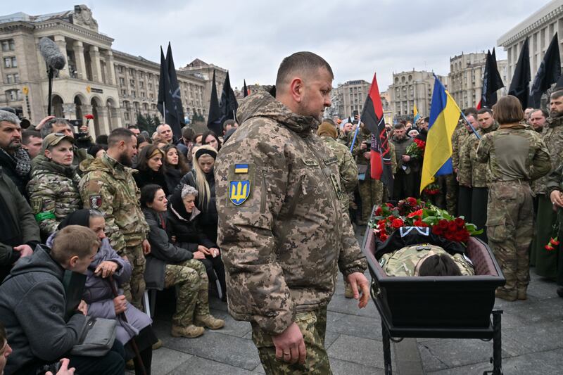 Commander-in-chief of the Armed Forces of Ukraine Valerii Zaluzhnyi stands next to the open coffin of Dmytro Kotsiubailo, a Ukrainian serviceman killed in combat on the front line in Bakhmut, during a memorial ceremony at Independence Square in Kyiv in March. Photograph: Sergei Supinsky/AFP via Getty Images