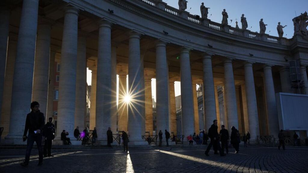People walk through St Peter's Square as workers prepare for the inauguration mass of Pope Francis yesterday in Vatican City. The Inauguration Mass for Pope Francis will take place today, the feast day for St Joseph. Photograph: Spencer Platt/Getty Images