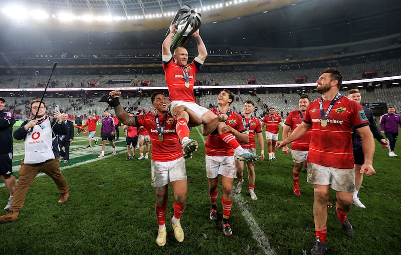 Keith Earls holds the trophy as he is hoisted on the shoulders of Malakai Fekitoa and Antoine Frisch after the URC Final win over the Stormers at DHL Stadium in Cape Town. Photograph: James Crombie/Inpho