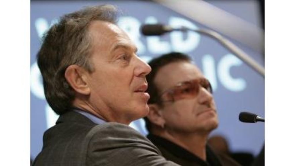 Britain's prime minister Tony Blair and U2 lead singer Bono at
the session Delivering on the Promise of Africa at the World
Economic Forum in Davos, Switzerland, yesterday. Bono said he
feared debt promises might not be kept: if we fail it's corruption
at the highest order, he said.