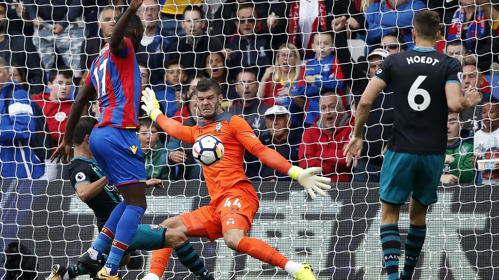 Southampton goalkeeper Fraser Forster saves a shot from Crystal Palace striker Christian Benteke. Photograph: Getty Images