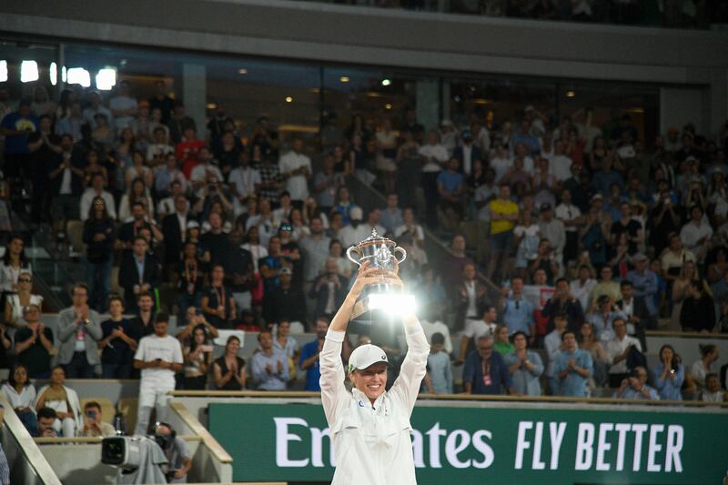 Iga Swiatek with her trophy after defeating Coco Gauff at the French Open in Paris on Saturday. Photograph: James Hill/The New York Times