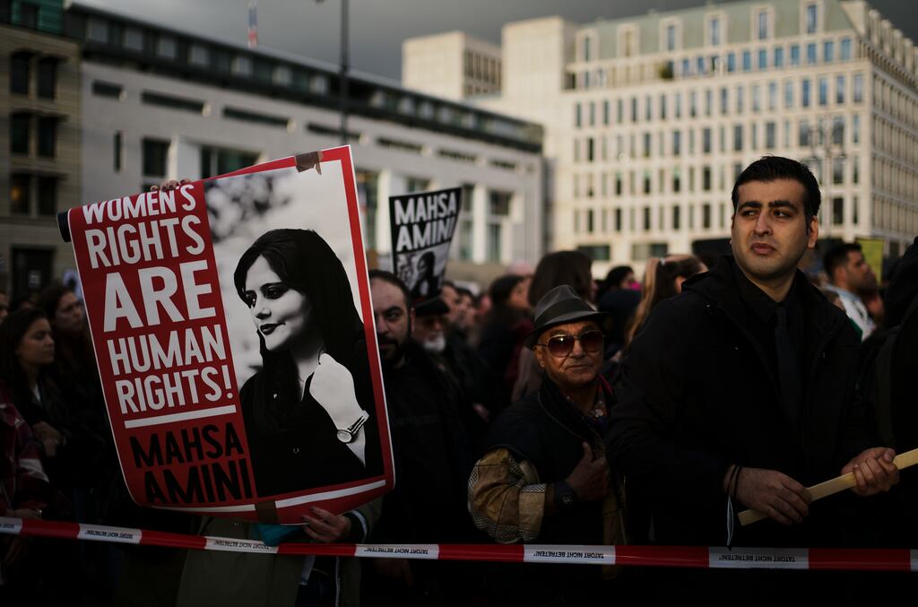 Demonstrators display posters as they attend a protest against the death of Iranian Mahsa Amini in Berlin, Germany on Wednesday. Amini, a 22-year-old woman who died in Iran while in police custody, was arrested by Iran’s morality police for allegedly violating its strictly-enforced dress code. Photograph: Markus Schreiber/AP