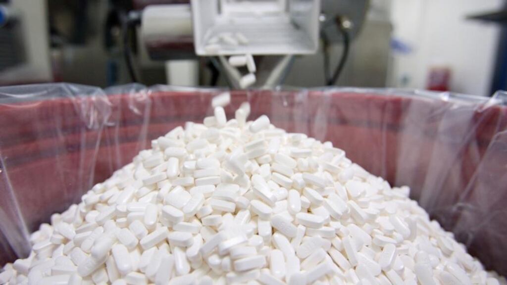 Merck Sharpe & Dohme cholesterol-lowering drug, Vytorin, emerges from a tablet press. Photographer: Jonathan Drake/Bloomberg News