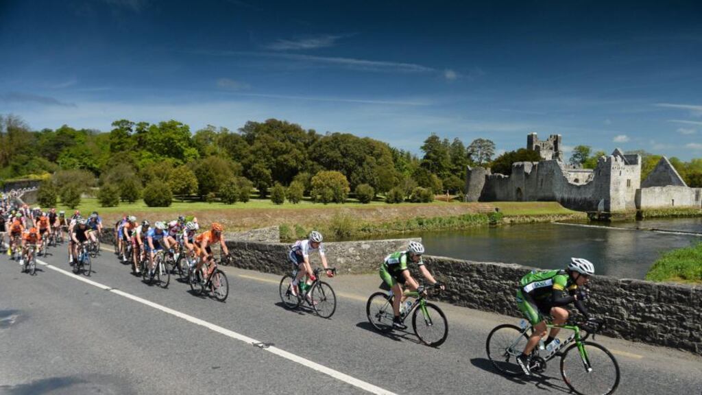Eventual stage winner Sam Bennett of An Post Chain Reaction lies behind team-mate Shane Archbold as they enter Adare, Co Limerick, during stage three of the An Post Rás yesterday. Photograph: Inpho