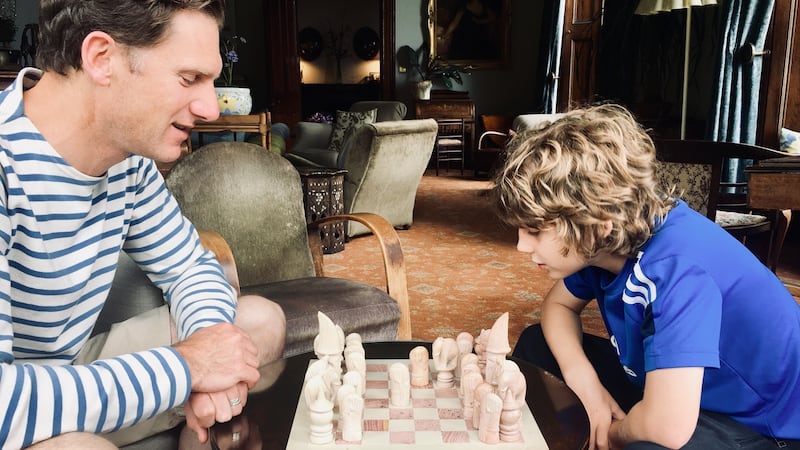 Fergal McCarthy and his son Dash playing chess in the livingroom in Currarevagh House