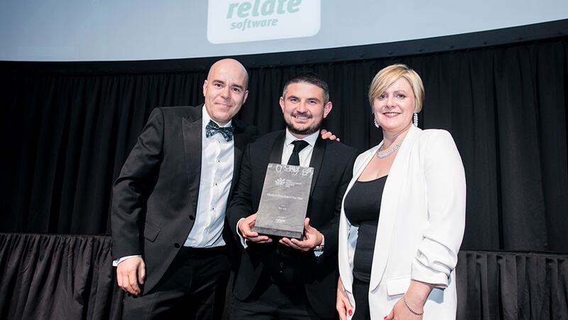 Luke Halpin, on behalf of Relate Software Group, presents the Medium Practice of the Year award to David O'Reilly & Sinead Doherty, Fenero.