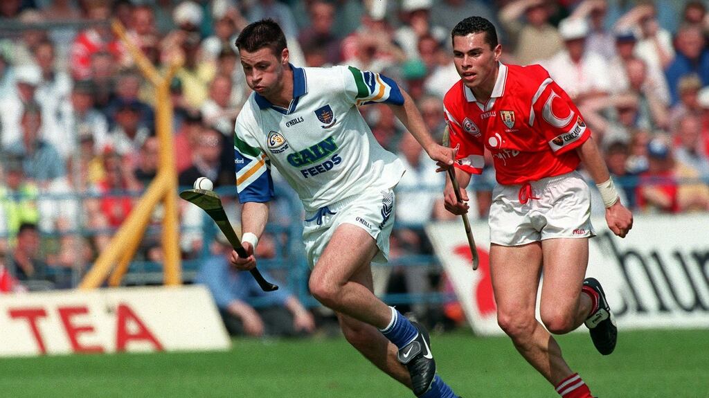 Waterford’s Dan Shanahan is chased by Séan Óg Ó gAilpín during the National Hurling League final of 1998. Photograph: Patrick Bolger/Inpho