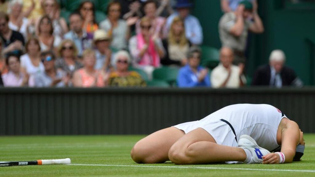 Marion Bartoli of France reacts as she defeats Kirsten Flipkens of Belgium in their women’s semi-final at the Wimbledon. Photograph: Toby Melville/Reuters