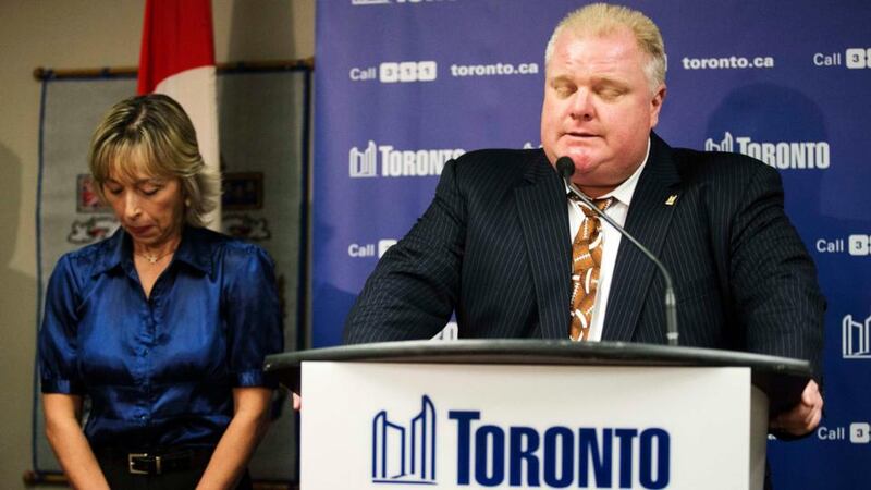 Toronto Mayor Rob Ford speaks at a news conference with his wife Renata (L) at City Hall in Toronto last night. Ford, under pressure to resign after he admitted smoking crack and buying illegal drugs, said  he was receiving professional help for drinking problems, but gave no hint he might step down. Photograph: Mark Blinch/Reuters.