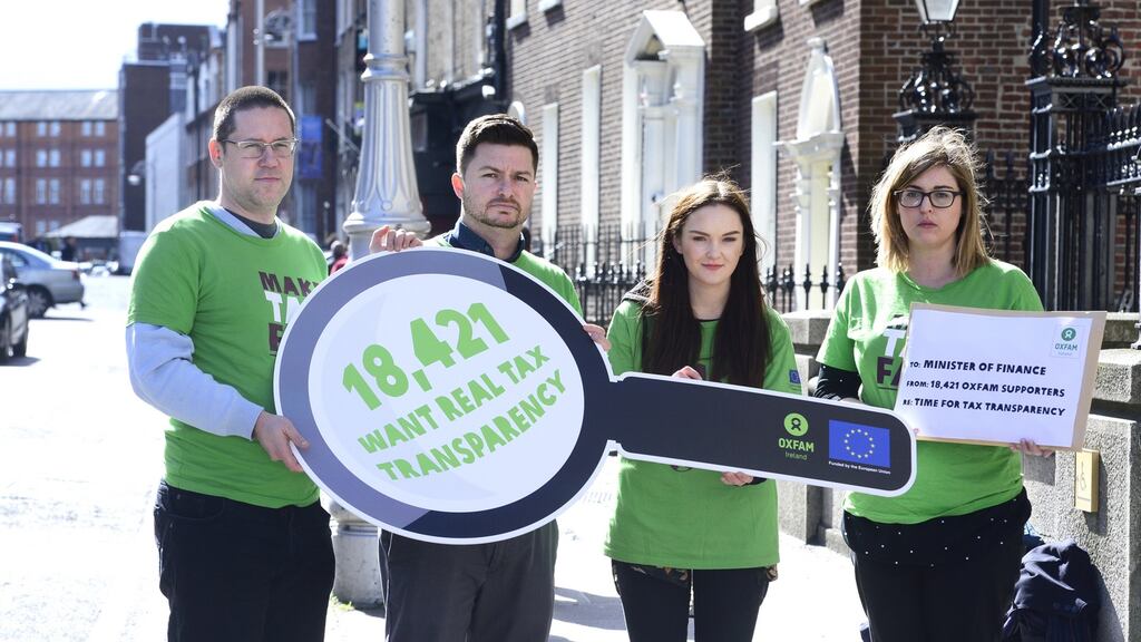 Oxfam campaigners pictured outside the Department of Finance earlier this year, where they called on the Government to implement real transparency around where large companies make profit and pay tax. Photograph: Cyril Byrne