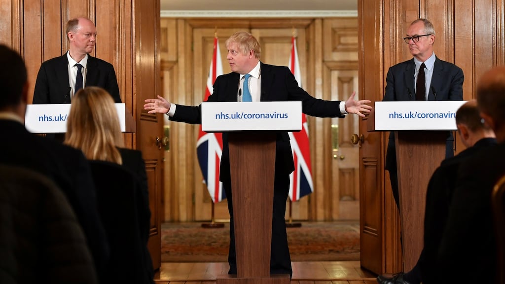 Britain’s chief Medical officer Prof Chris Whitty (L) and chief scientific adviser Patrick Vallance look on as British prime minister Boris Johnson gestures as he speaks during a Covid-19 news conference inside 10 Downing Street on Thursday. Photograph: Leon Neal/Pool via Reuters