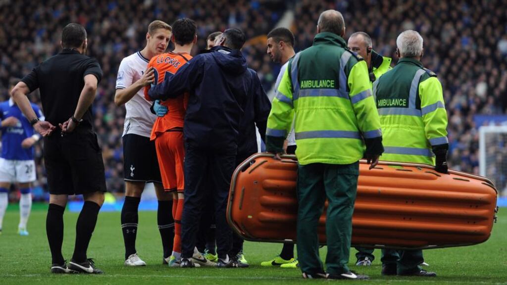 Hugo Lloris receives treatment following the collision. Photograph: Chris Brunskill/Getty Images