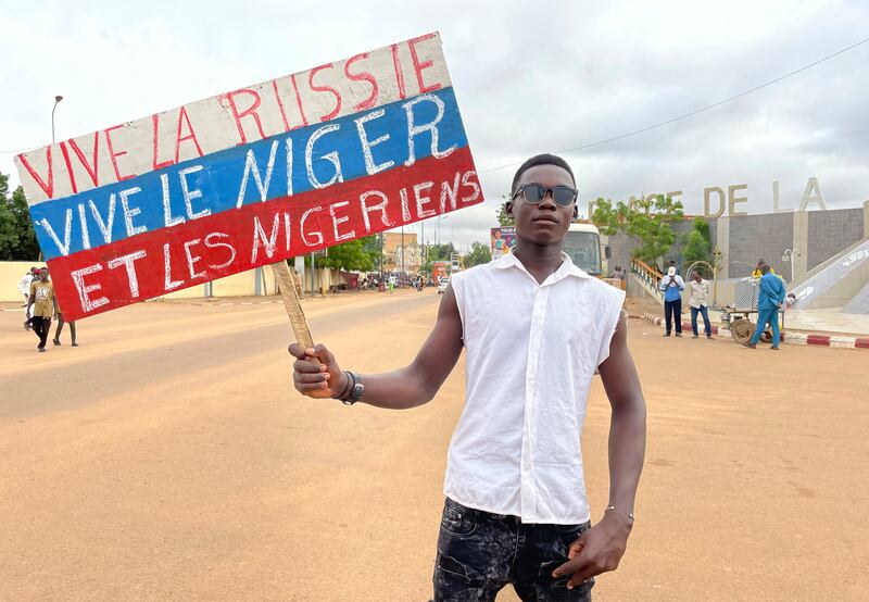 A supporter of Niger’s ruling junta holds a placard in the colours of the Russian flag reading ‘Long Live Russia, Long Live Niger and Nigeriens’ in Niamey, Niger. Photograph: Sam Mednick/AP