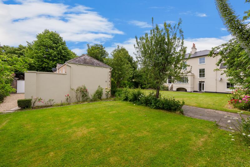 The back garden with the side of coach house visible.