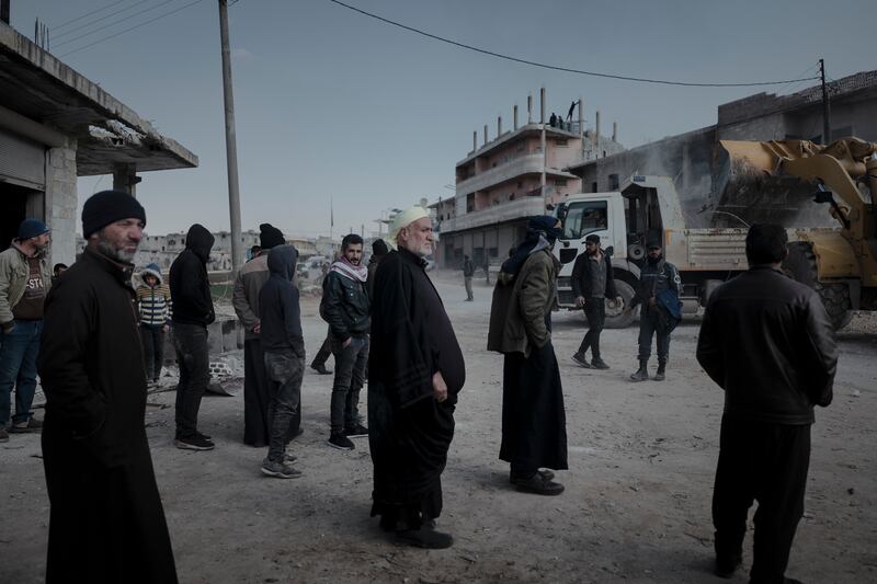 Men watch rubble being removed on Monday in al-Atarib, Aleppo province, Syria. 'What could Syrians possibly have committed to deserve to be trapped in those circles of hell?' asks Suad Aldarra of the suffering in her country. Photograph: Emily Garthwaite/The New York Times