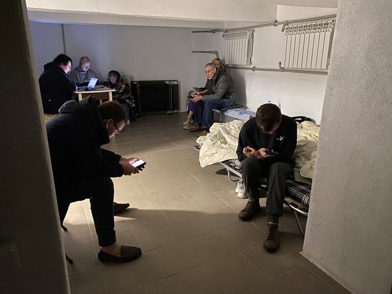 People take shelter in the basement of their residential building during a night drone and missile strike. Photograph: Ania Tsoukanova/AFP