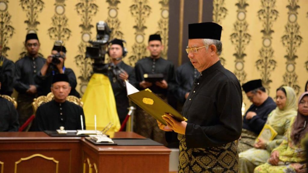 Malaysia’s Prime Minister Najib Razak takes his oath during a swearing-in ceremony at the palace in Kuala Lumpur