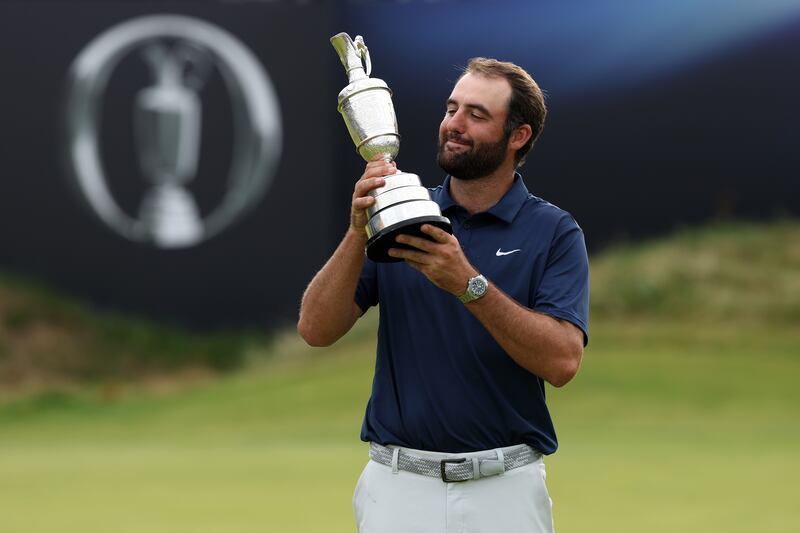 Scottie Scheffler poses with the Claret Jug on the 18th green after winning The Open. Photograph: Richard Heathcote/Getty Images