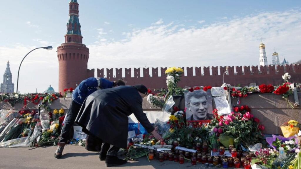 People lay flowers at the spot where Russian opposition politician Boris Nemtsov was murdered near the Kremlin on Grand Moskvorestsky bridge in Moscow. Photograph: Sergei Chirikov/EPA