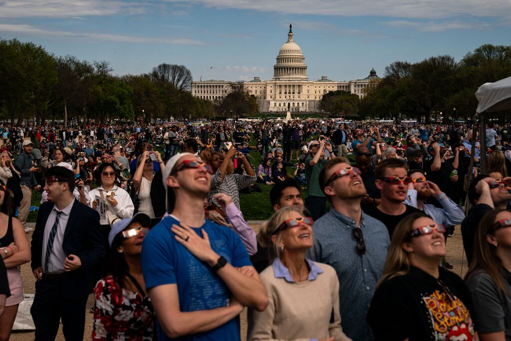 People gather on the National Mall in Washington, DC to view the partial solar eclipse on Monday. Photograph: Kent Nishimura/Getty Images