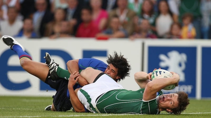 Brian O’Driscoll scores a try for Ireland against Namibia in 2007 despite a tackle from Tertius Losper. Photograph: Billy Stickland/Inpho