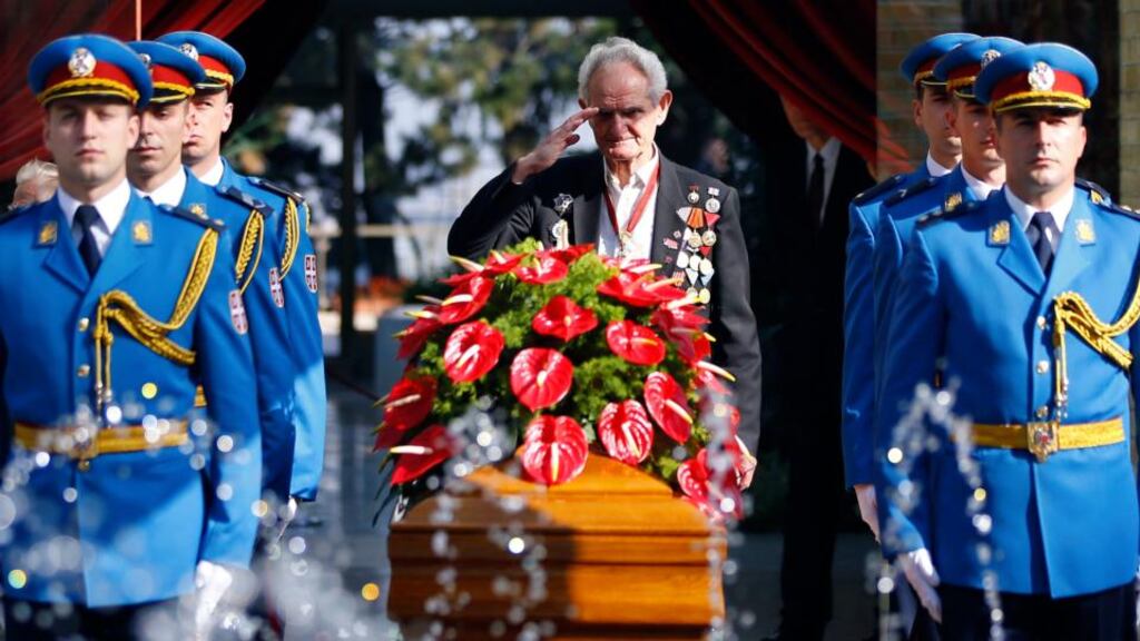 A World War Two veteran salutes as honour guards stand beside the coffin of Jovanka Broz, in front of the House of Flowers mausoleum where she was buried next to her husband, former Yugoslav leader Josip Broz Tito, in Belgrade. Photograph: Marko Djurica/Reuters