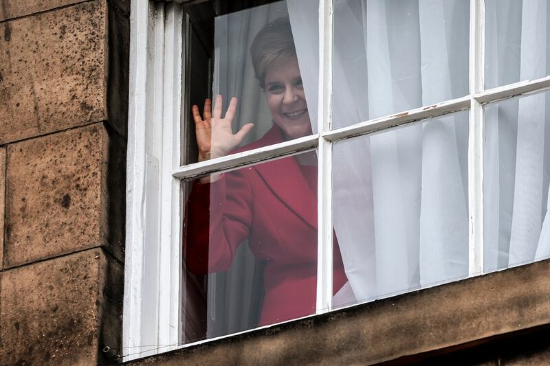 Nicola Sturgeon waves from a window after holding a press conference to announce that she is stepping down as SNP leader. The race to succeed her has at times been brutal. Photograph: Jeff J Mitchell/Getty Images